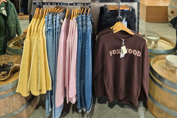 Clothing display with sweatshirts and pants in a store setting